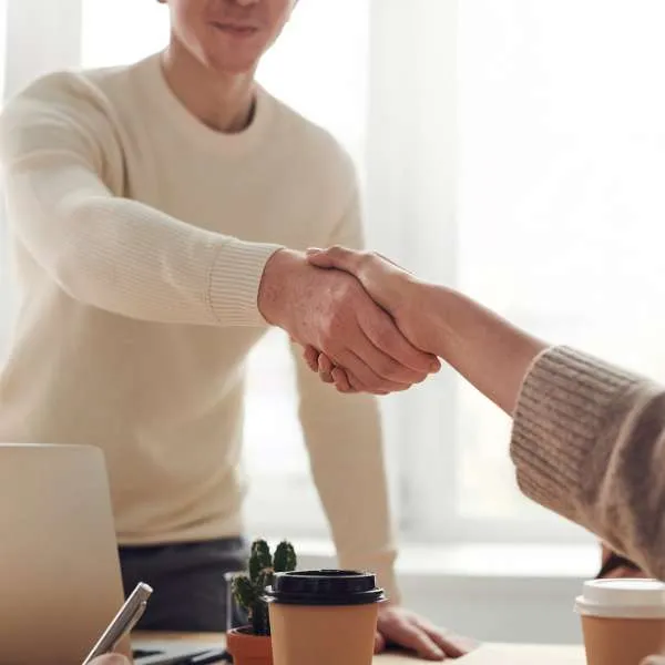 Handshake across a desk at the end of a meeting